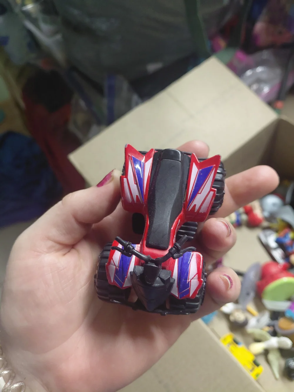 a Greenbrier International EX500 3-inch die-cast red quad ATV toy,